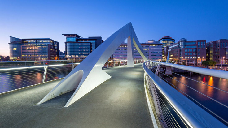 Glasgow's "Squinty Bridge" over the River Clyde in the early evening - the city's Financial Services District is in the background.
